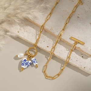 Gold chain necklace with blue and white porcelain charms, pearl and toggle clasp
