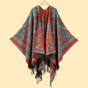 Close-up of red and blue cashmere-like shawl featuring intricate paisley patterns and black tassels