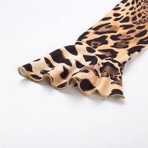 Close-up of leopard print top featuring ruffled cuffs and golden stitch details