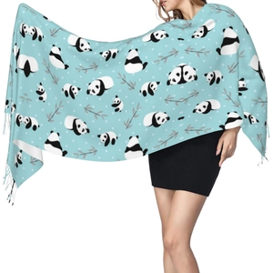 Detail of light blue cashmere-feel scarf with panda and bamboo pattern and fringe trim