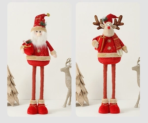 Detail of plush Christmas gnome and reindeer dolls with red sequins and gold stars