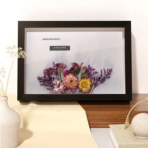 Black wooden 3D shadow box frame featuring handmade dried flower art for home decor