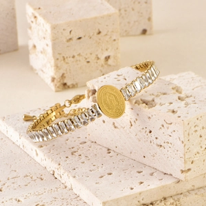 Detailed shot of Guadalupe medal bracelet with rectangular zircons on travertine stone