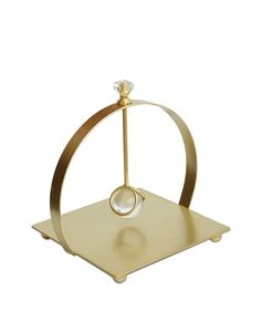 Close-up of golden iron tissue holder with crystal ball detail and square base
