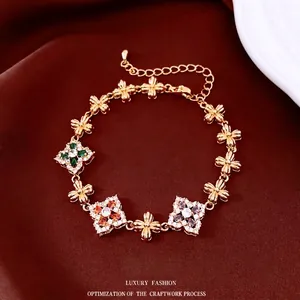 18K gold plated flower bracelet with colorful gemstones on a dark silk background