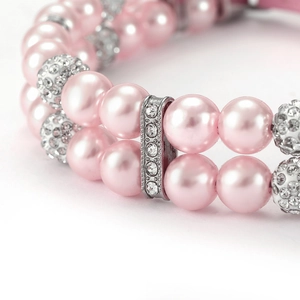 Macro shot of double-layer pink pearl pet collar with silver rhinestone dividers