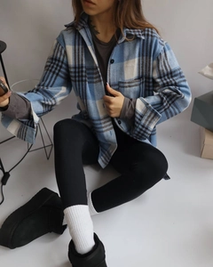 Close-up of thick blue and brown plaid flannel shirt with drop shoulder and soft texture