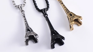 Detailed trio of vintage Eiffel Tower pendants in silver, black, and antique gold finishes