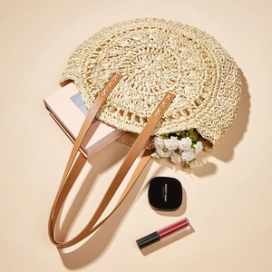 Hollow-out woven round straw shoulder bag with brown leather straps for beach vacation