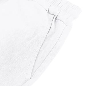 Detail of white linen shorts featuring elastic waistband and side pockets macro view