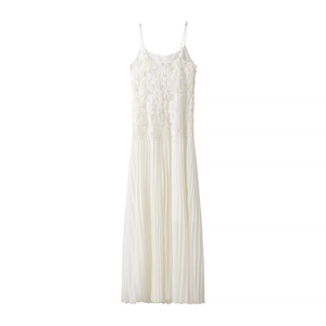Detail of delicate 3D floral embroidery and pleated chiffon hem on white maxi dress
