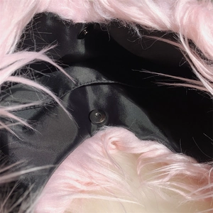Detail view of pink faux fur tote bag interior featuring secure metal magnetic snap closures