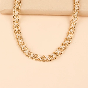 Close-up of golden metal chain woven with white pearls for a luxury belt texture