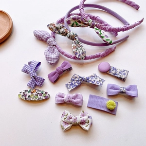 Detailed set of purple floral and checkered fabric hair clips with bow headbands for girls