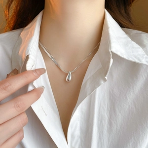 Elegant silver layered necklace with teardrop pendant on minimalist snake chain for women
