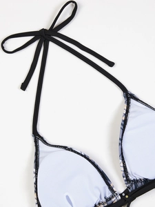 Detailed close-up of bikini top showing black halter straps and white inner lining cups