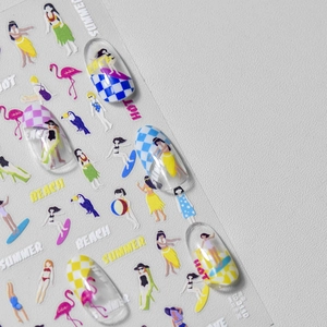 Detail view of summer beach nail stickers featuring flamingos and surfing illustrations