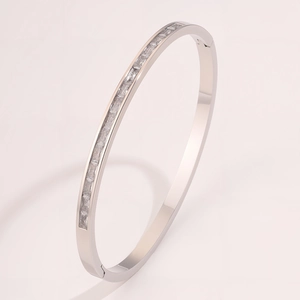 Close-up of titanium steel bangle with channel-set rectangular zircon in silver finish
