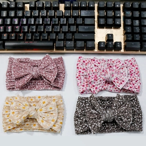 Detailed set of four floral baby headbands with large bows in soft fabric