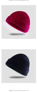 Detailed close-up of rose red and navy blue knitted beanies with rolled edge design