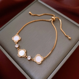 Detail of clover bracelet with white mother of pearl and shimmering zircon in gold plating