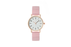 Detail of pink stretch metal strap and rose gold quartz watch case with numeric dial