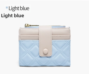 Close-up of light blue and beige bi-color wallet with diamond quilted stitching