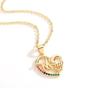 Detailed macro view of gold heart necklace featuring Mom engraving and colorful zircon stones