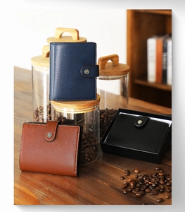 Three bifold leather wallets in blue, brown, and black with a premium gift box packaging