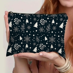 Blue Christmas toiletry bag with festive snowflake and tree prints held by model hands