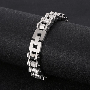 Detail of silver titanium steel bike chain bracelet on a professional black jewelry display
