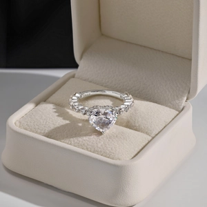 Close-up of S925 sterling silver heart-shaped zircon ring in a beige jewelry gift box