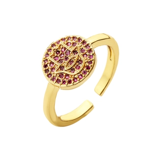 Adjustable gold-plated Hamsa hand ring with pavé pink cubic zirconia on white background