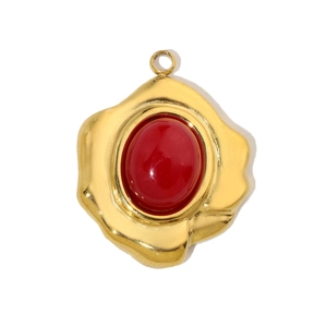 Detailed close-up of a gold-plated teardrop pendant featuring a red oval natural stone