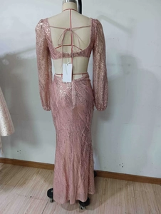 Detail of sequin long sleeve gown featuring an elegant open back design with tie closure