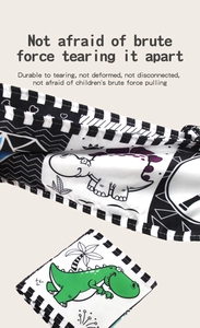 Detail showing tear-resistant baby cloth book with dinosaur and geometric patterns