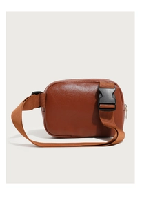 Detail showing brown pebble leather texture and durable black buckle on fanny pack