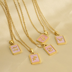 Five 18K gold stainless steel 12 Zodiac necklaces with pink enamel pendants on silk