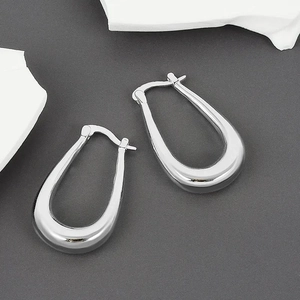 Detailed view of silver U-shaped earrings with a polished finish and latch back closure