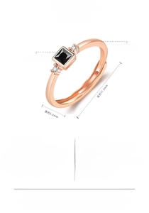 Detailed view of a minimalist rose gold adjustable ring with a square black stone.