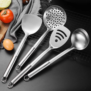 Polished stainless steel 4-piece kitchen utensil set with oval handles on a dark table