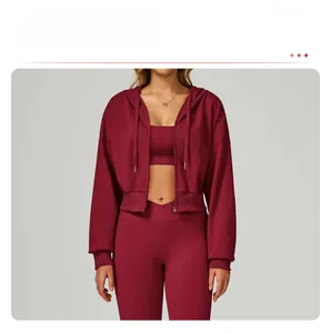 Detail of burgundy three-piece yoga set with zip-up hoodie and high-waist leggings
