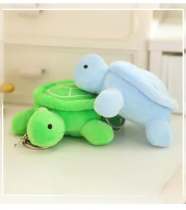 Detail of cute green and light blue plush turtle keychains with metal ring hooks