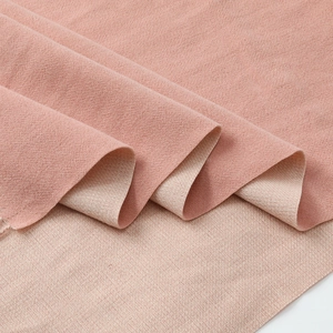 Detail showing the soft textured weave of the pink and beige double-sided cashmere scarf