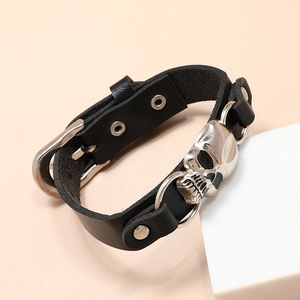 Punk style black leather bracelet with silver skull charms and adjustable buckle