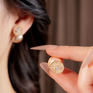 Detailed view of French vintage earrings featuring gold plating, zircon, and pearls