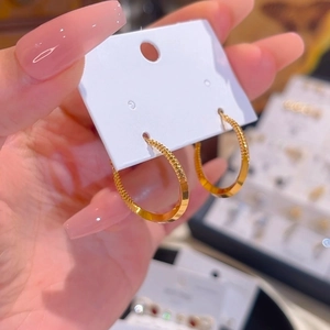 Minimalist 18k gold plated round hoop earrings with textured beaded pattern detail