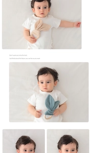 Detail showing baby wood ring with beige and teal cotton rabbit ears for grasping