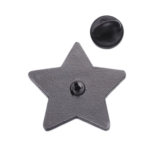 Detail of matte black star-shaped badge with its rubber clutch back on white background