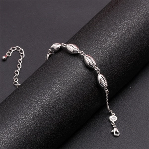 Macro shot of silver shell-shaped metal links bracelet with lobster clasp and extender